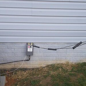 600 Ohm ladder line attached to a DX Engineering 4:1 balun with a short run of 20 ft of RG 8 coax into the shack connected to a LDG AT-1000 Autotuner