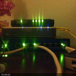 This is networking 101 - 

4 port switch (L3 capable, but in L2 mode)
Linksys VoIP device
Juniper SRX-100