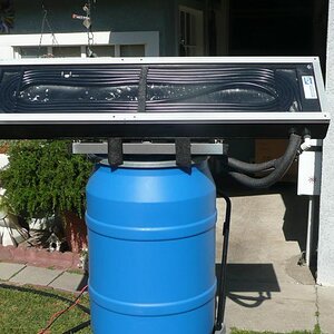 First test of the solar water heater with the new design collector. I used 40 feet of 1/2" ID black vinyl pond hose coiled inside.
