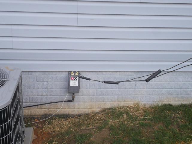 600 Ohm ladder line attached to a DX Engineering 4:1 balun with a short run of 20 ft of RG 8 coax into the shack connected to a LDG AT-1000 Autotuner