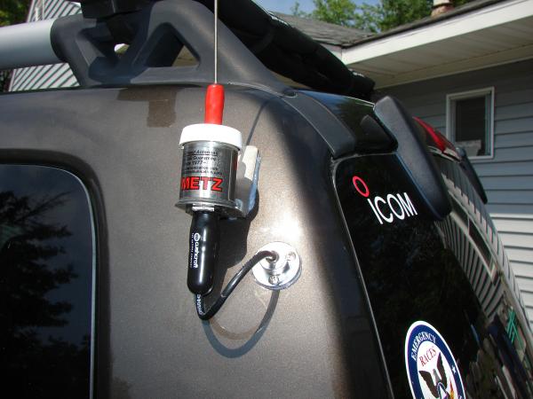 Close up of Metz 2 meter mobile antenna installation on my '05 Jeep Liberty. Used a marine fitting to run the coax through the metal body inside the v
