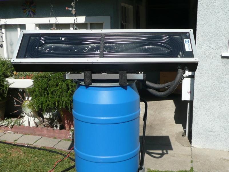 First test of the solar water heater with the new design collector. I used 40 feet of 1/2" ID black vinyl pond hose coiled inside.
