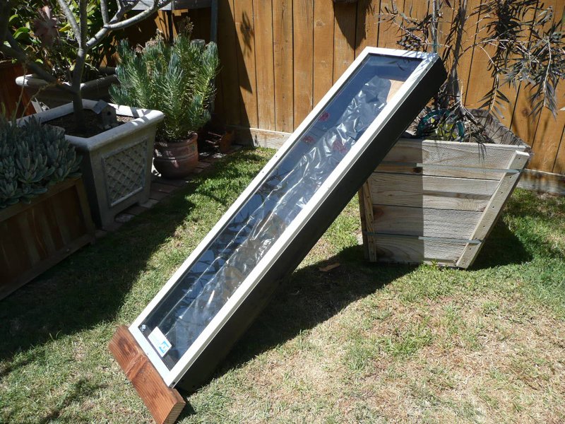 Making a new solar 'collector' from a discarded 'doggy door' insert (from a sliding glass door cut down to 54"x15"). The box is constructed from 2 x 4